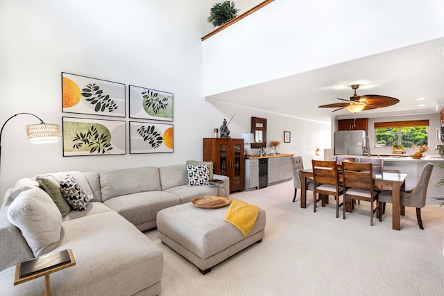 carpeted living room with ceiling fan