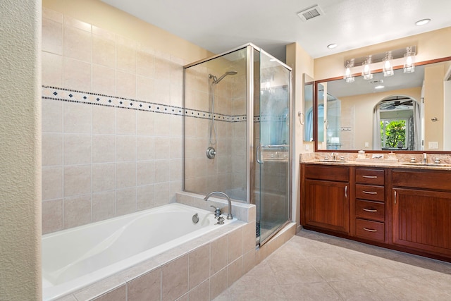 bathroom with tile patterned flooring, independent shower and bath, and vanity