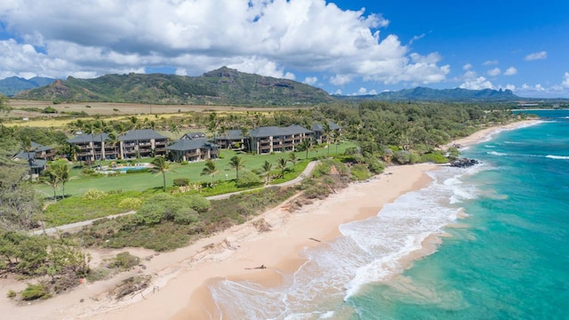 view of mountain feature with a beach view and a water view