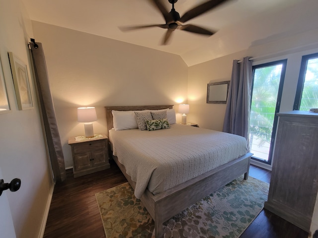 bedroom featuring ceiling fan, multiple windows, access to exterior, and dark hardwood / wood-style floors