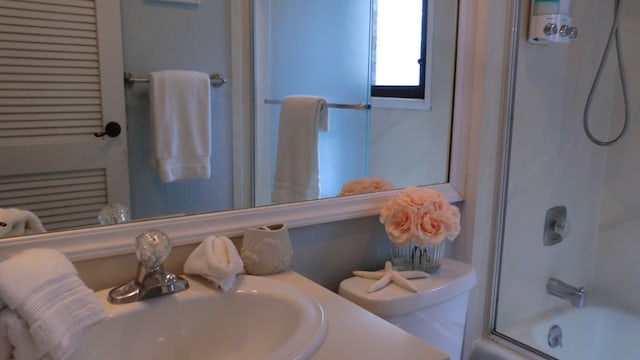 full bathroom with toilet, shower / bath combination with glass door, and vanity