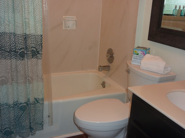 full bathroom with vanity, shower / bathtub combination with curtain, and toilet