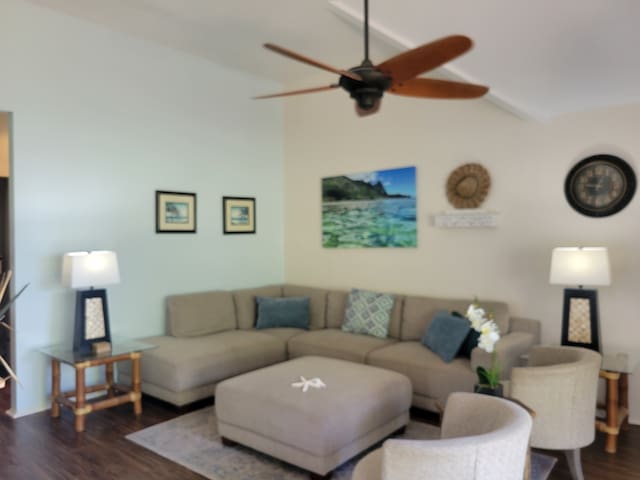 living room with ceiling fan, lofted ceiling, and wood-type flooring