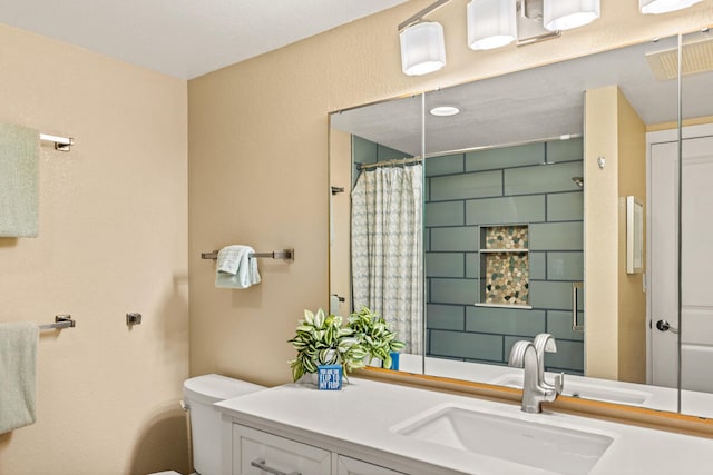 bathroom featuring toilet, a shower with curtain, and vanity