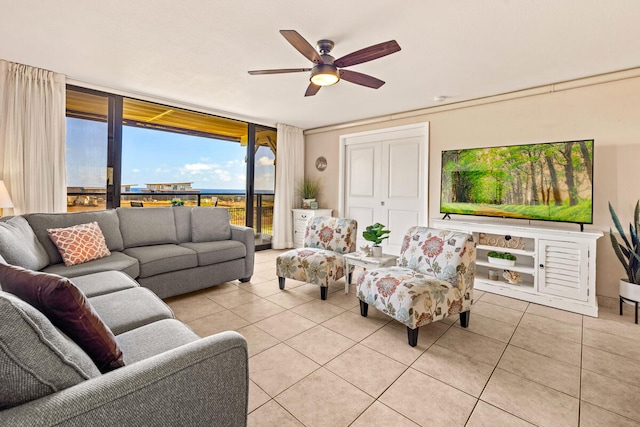 living room featuring expansive windows, light tile patterned floors, and ceiling fan