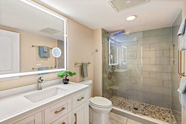 bathroom with vanity, tile patterned floors, toilet, and a textured ceiling