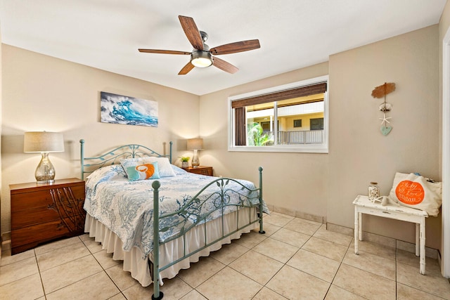 tiled bedroom featuring ceiling fan