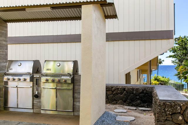 view of patio / terrace featuring area for grilling and a water view