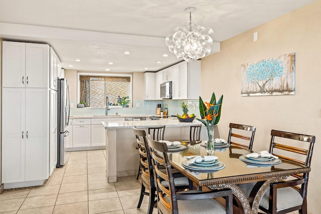 tiled dining space featuring sink