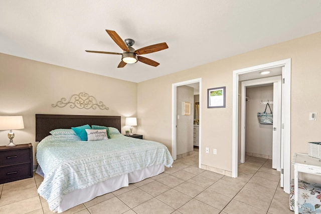 bedroom with ensuite bathroom, ceiling fan, and light tile patterned flooring