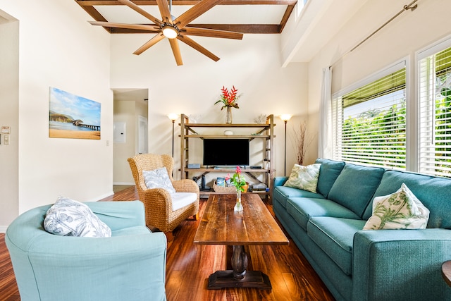 living room featuring ceiling fan, beamed ceiling, dark wood-type flooring, and a high ceiling