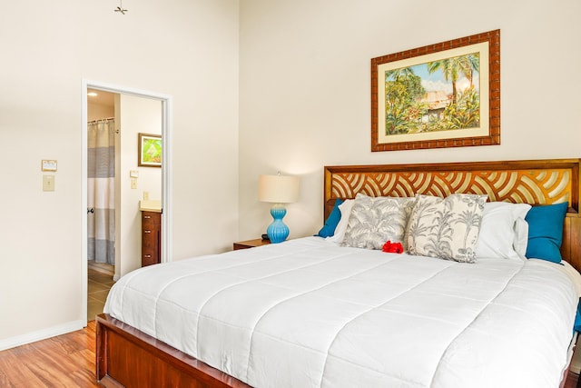 3880 Wyllie Rd Unit 26A, Princeville, HI 96722 - bedroom with wood finished floors, ensuite bathroom, and baseboards