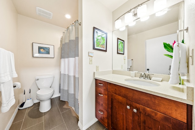 bathroom featuring tile patterned floors, vanity, and toilet