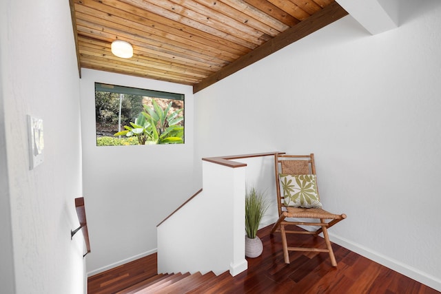 stairs featuring wood finished floors, wood ceiling, and baseboards