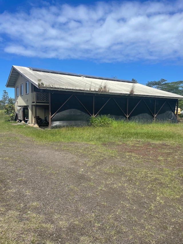 view of property exterior with a pole building and an outdoor structure