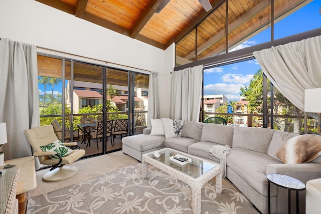 carpeted living room with vaulted ceiling with beams and wooden ceiling