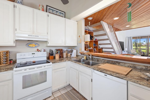 kitchen featuring white appliances, white cabinets, a sink, and under cabinet range hood