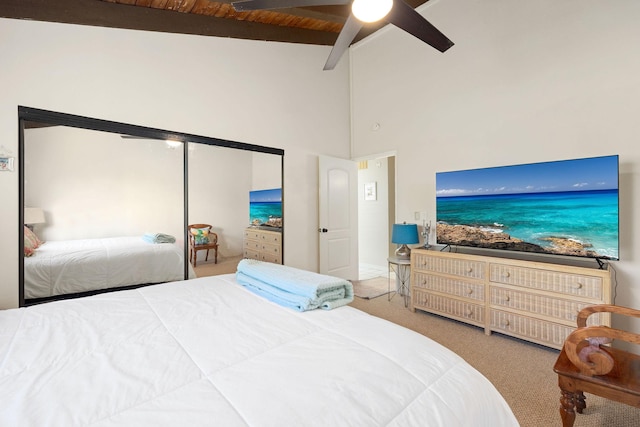 carpeted bedroom with vaulted ceiling with beams, wood ceiling, and ceiling fan