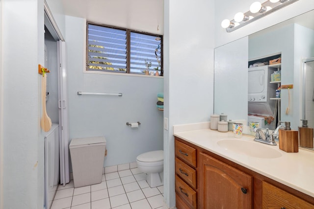 full bathroom featuring stacked washer / dryer, tile patterned flooring, vanity, and toilet