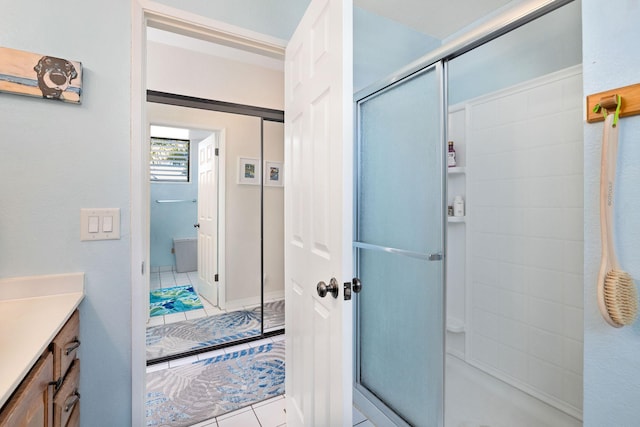 bathroom featuring a stall shower, vanity, and tile patterned floors