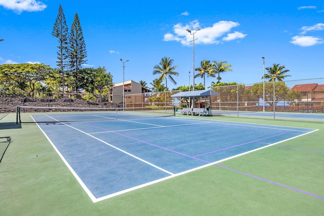 view of tennis court with fence