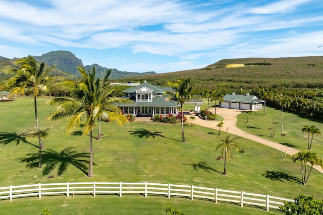 view of home's community featuring a mountain view, a yard, and a rural view