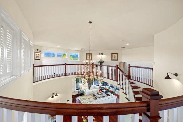 staircase with an inviting chandelier