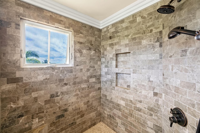 bathroom featuring a healthy amount of sunlight, a tile shower, and ornamental molding