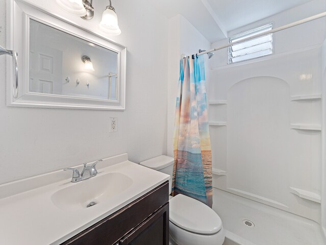 bathroom with vanity, a shower with curtain, and toilet