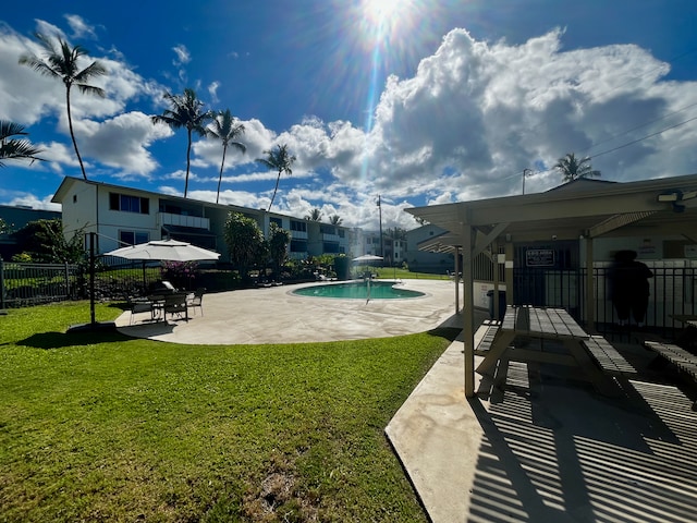 view of pool featuring a yard, pool water feature, and a patio