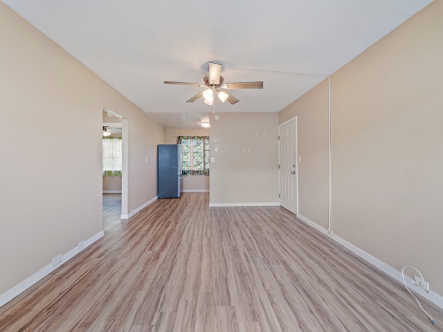 spare room featuring ceiling fan and light wood-type flooring