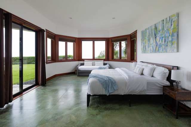 bedroom featuring access to exterior and concrete floors