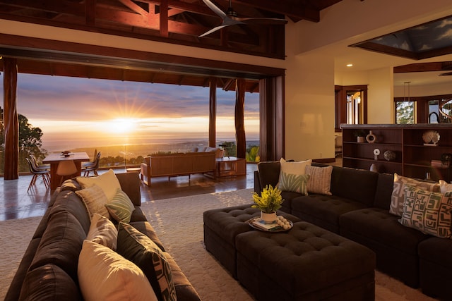 living room with beam ceiling and ceiling fan