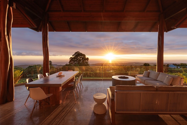 patio terrace at dusk featuring an outdoor living space with a fire pit