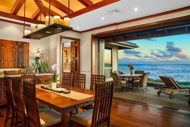 dining area with beam ceiling, dark hardwood / wood-style flooring, and a water view