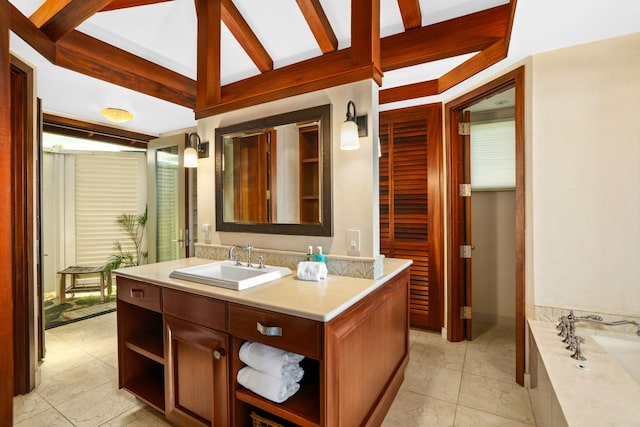 bathroom featuring tile patterned floors, vanity, and a tub to relax in