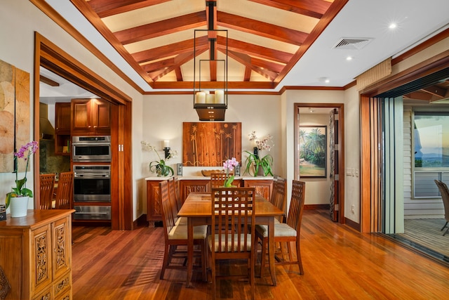 dining room with dark wood-type flooring and lofted ceiling with beams