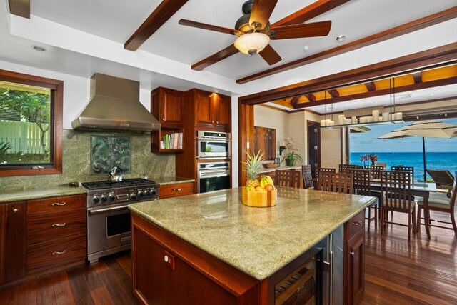 kitchen featuring stainless steel appliances, decorative backsplash, wall chimney exhaust hood, dark hardwood / wood-style flooring, and a center island