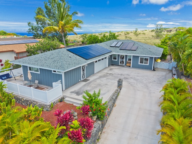 view of front of house with a garage and solar panels