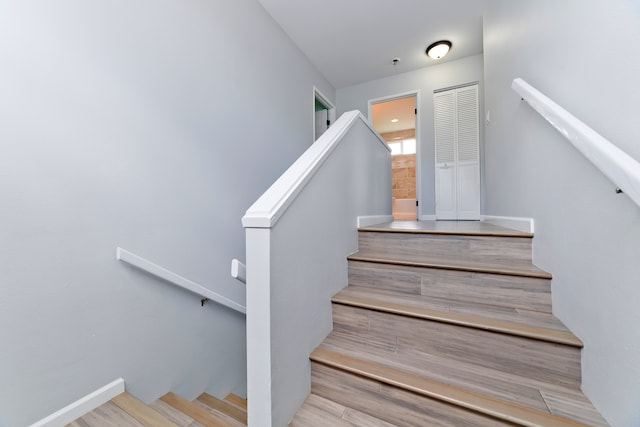 stairs with hardwood / wood-style flooring