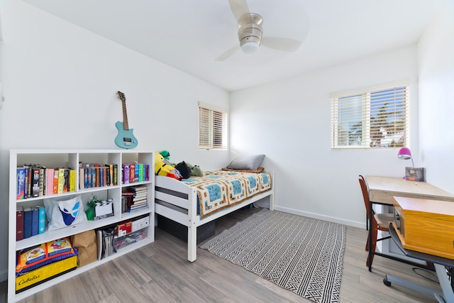 bedroom with ceiling fan and hardwood / wood-style flooring