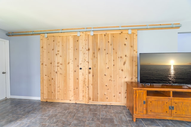 unfurnished living room with a barn door