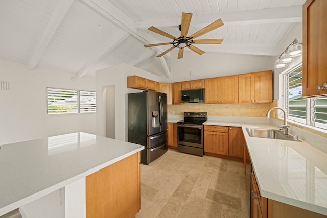 kitchen with ceiling fan, sink, appliances with stainless steel finishes, and vaulted ceiling with beams