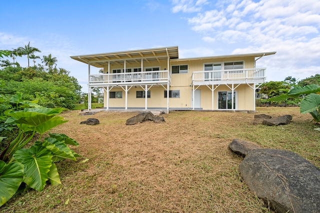 back of house featuring a balcony