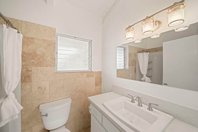 bathroom with vanity, toilet, a shower with curtain, and tile walls