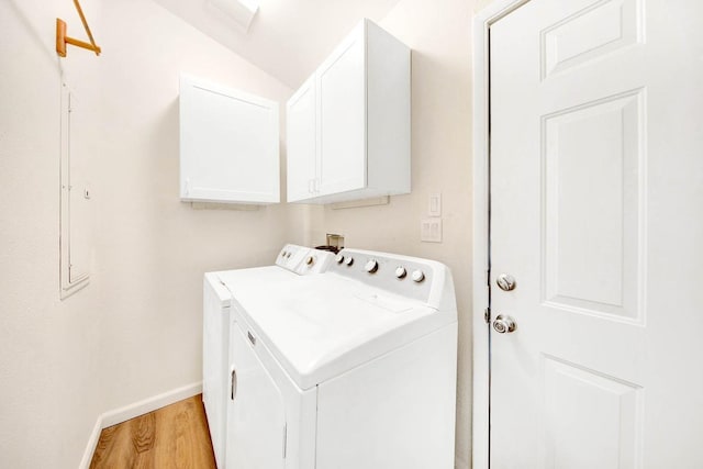 laundry room featuring light wood-type flooring, cabinet space, baseboards, and separate washer and dryer