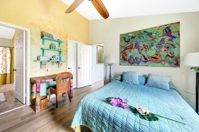 bedroom featuring ceiling fan, high vaulted ceiling, and wood finished floors