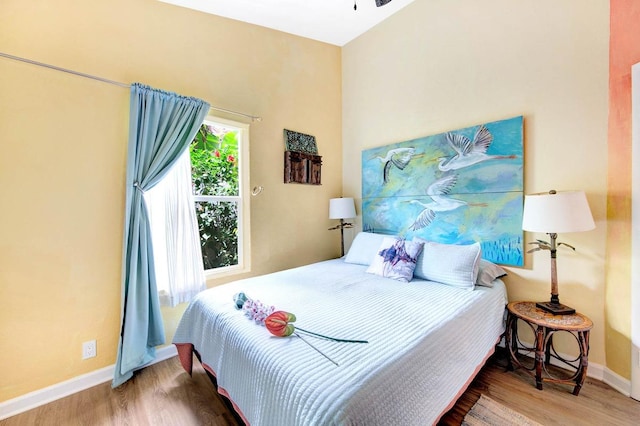 bedroom with wood finished floors and baseboards