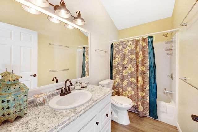 bathroom featuring shower / tub combo with curtain, vanity, toilet, and wood finished floors