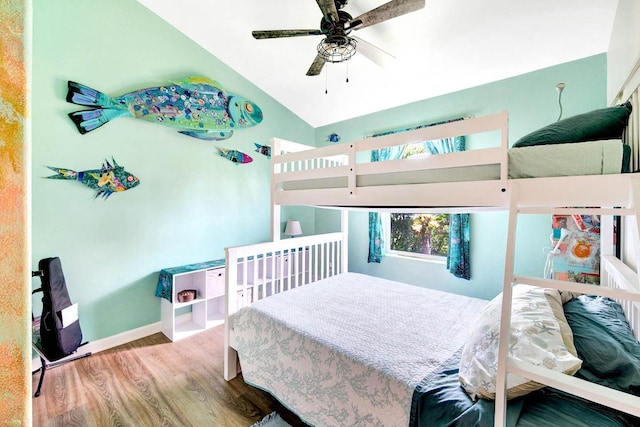 bedroom with lofted ceiling, baseboards, and wood finished floors